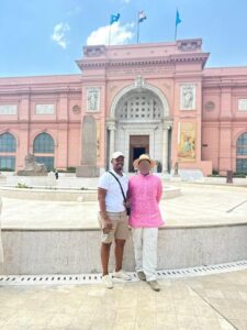 pink top and straw hat with 1 male